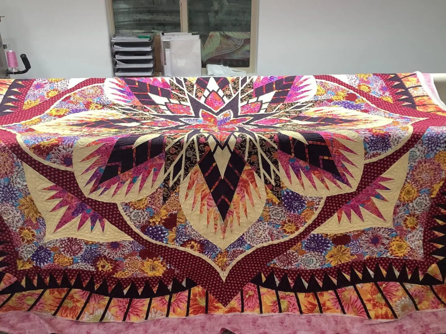 A bed with a colorful quilt on it