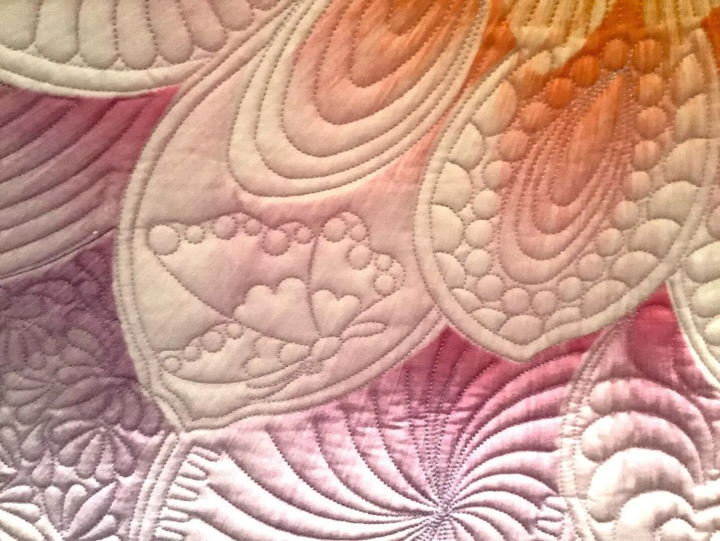 A close up of the quilting on a quilt.