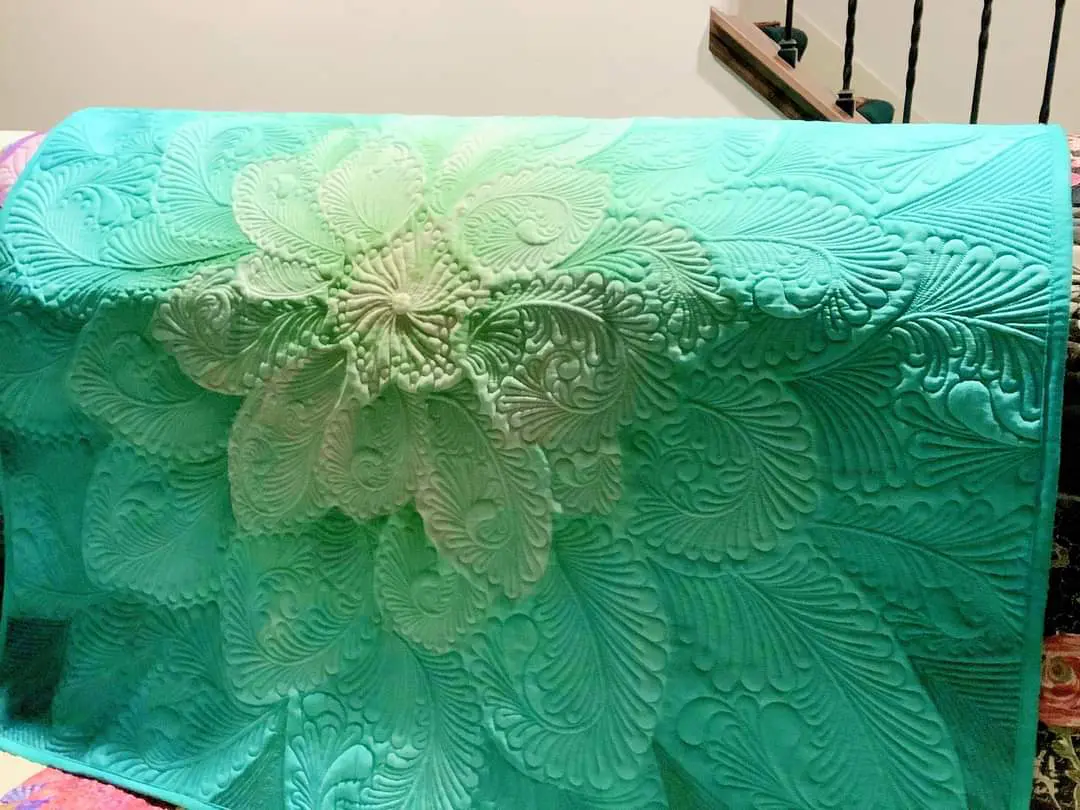 A close up of the flower on a green blanket