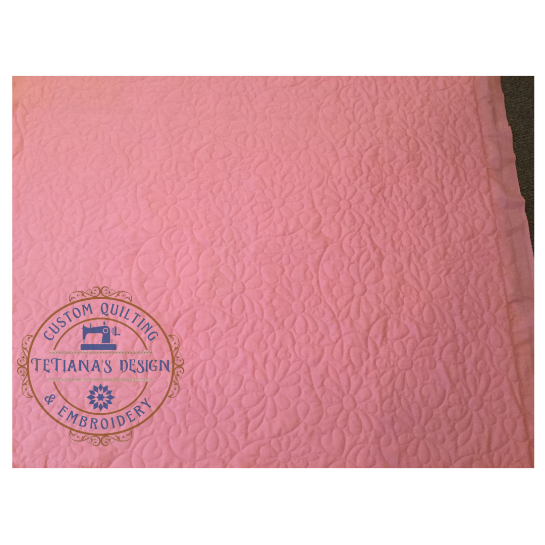 A close up of the pink fabric with a blue stamp