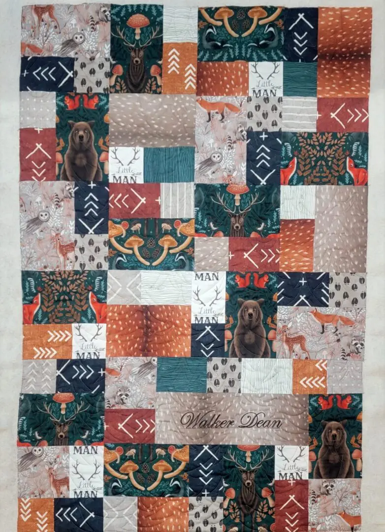 A quilt with different colored squares and animals.