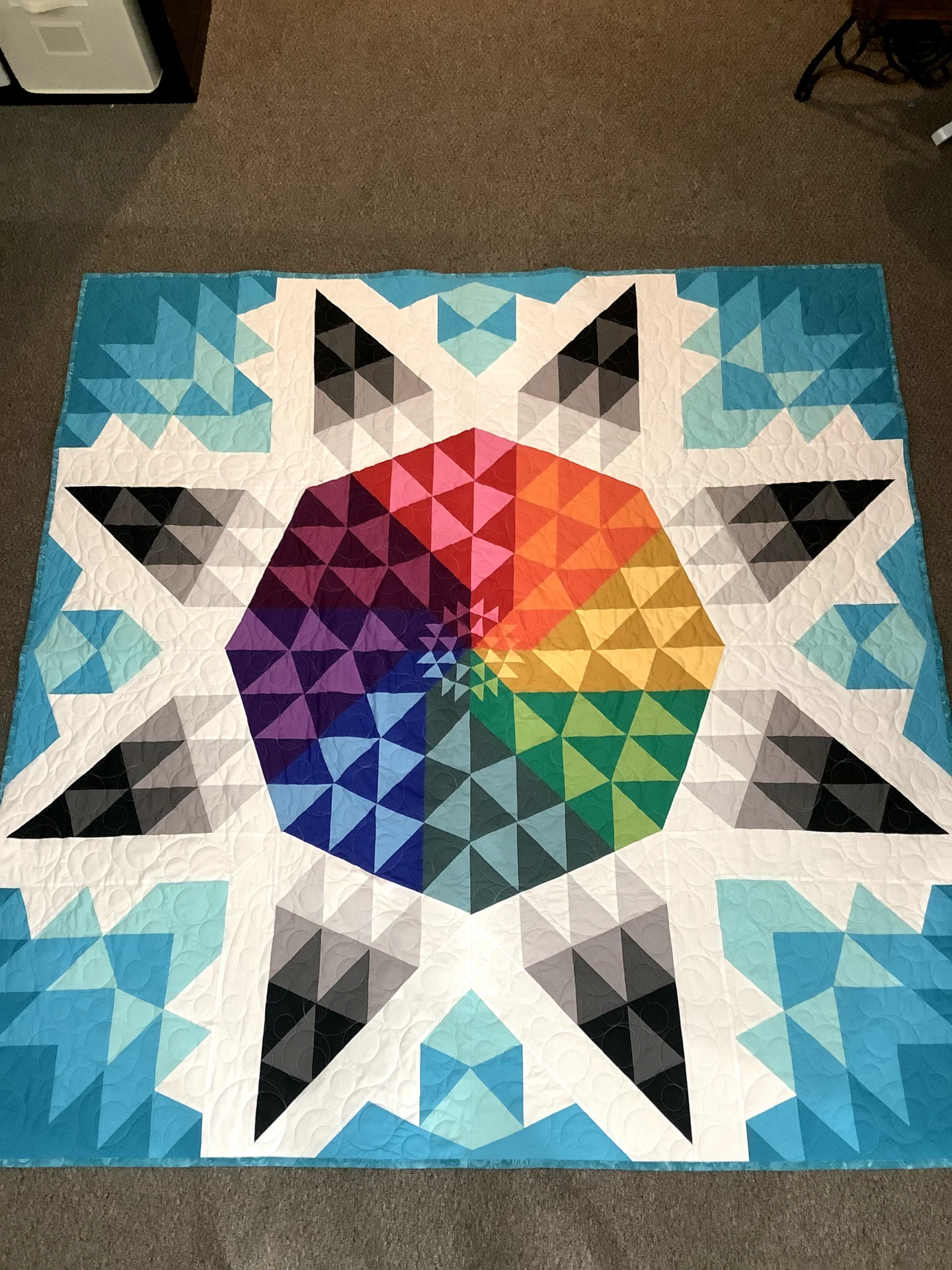 A colorful quilt with a star design on it.