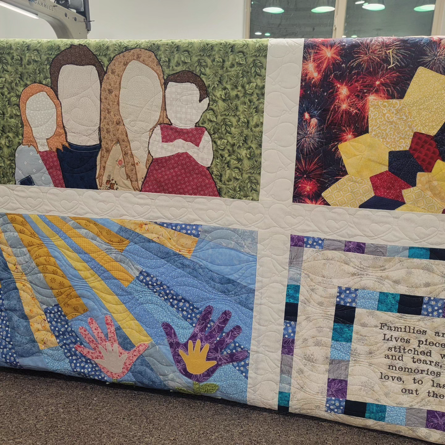 A close up of a quilt with pictures on it