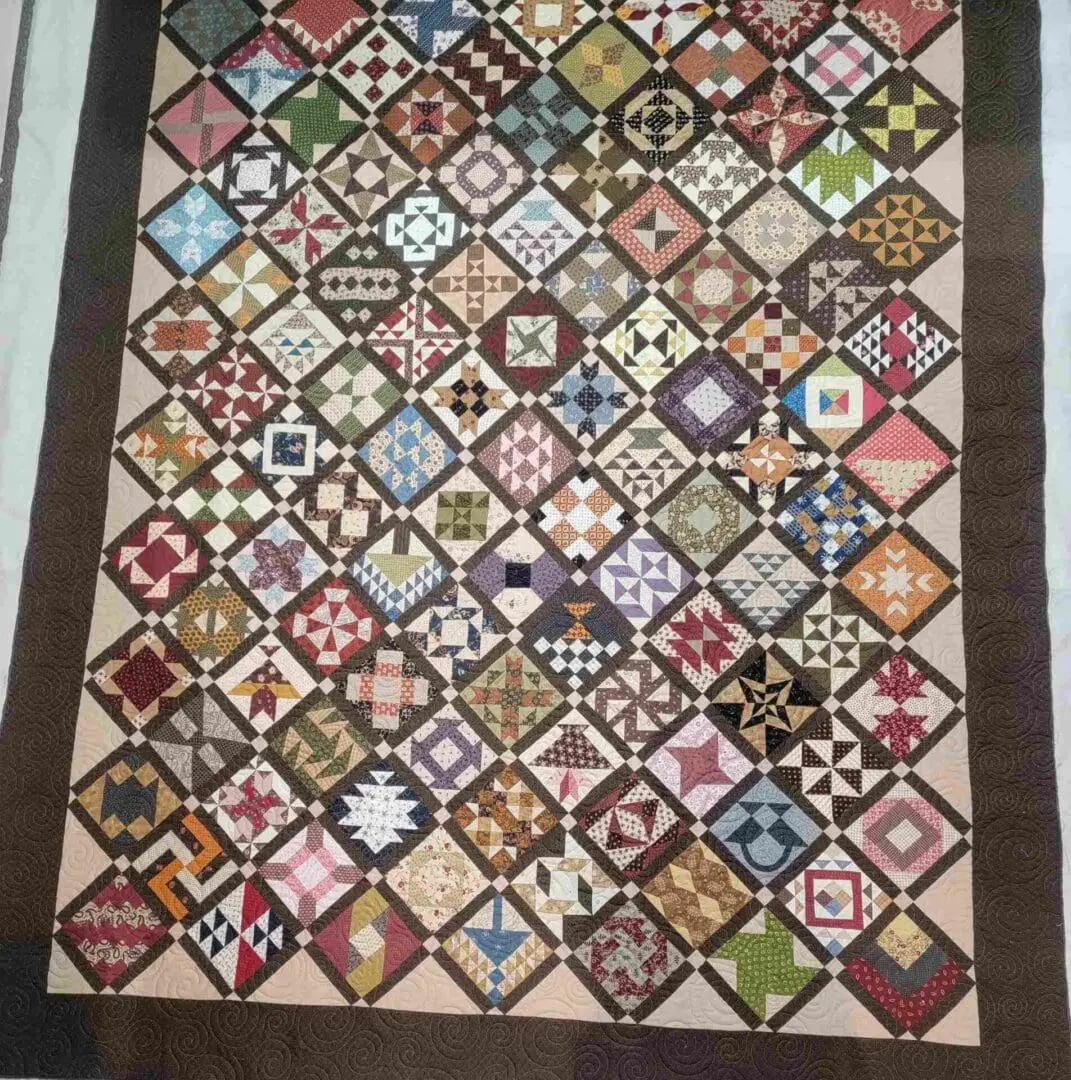 A quilt with many different colors and designs