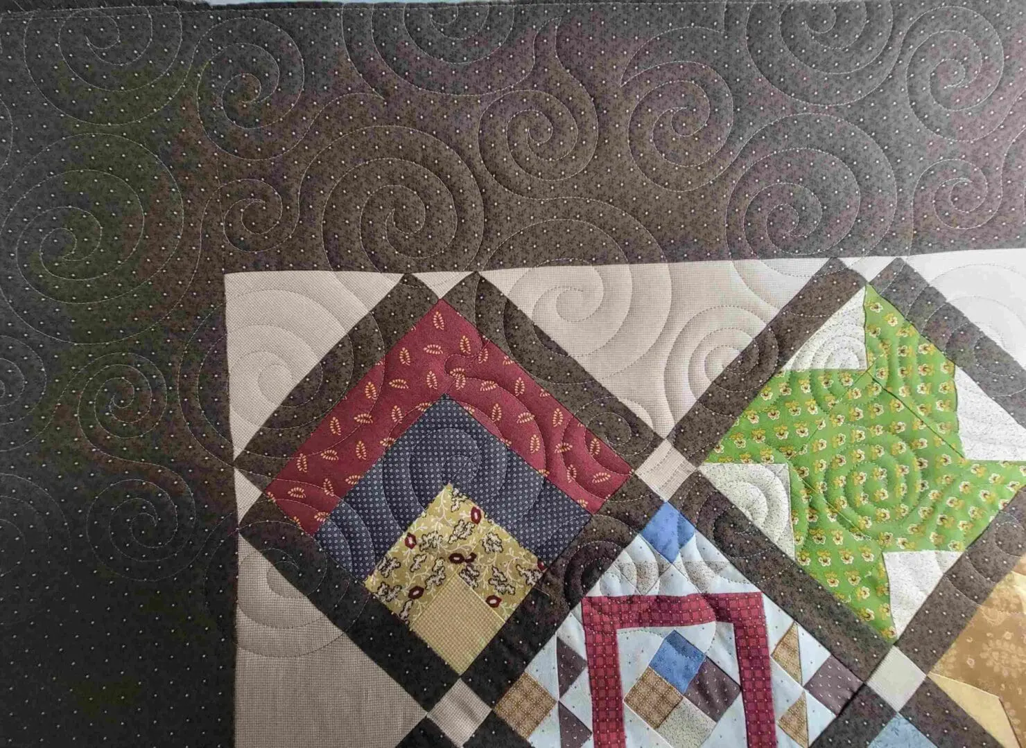 A close up of the quilt with different colors