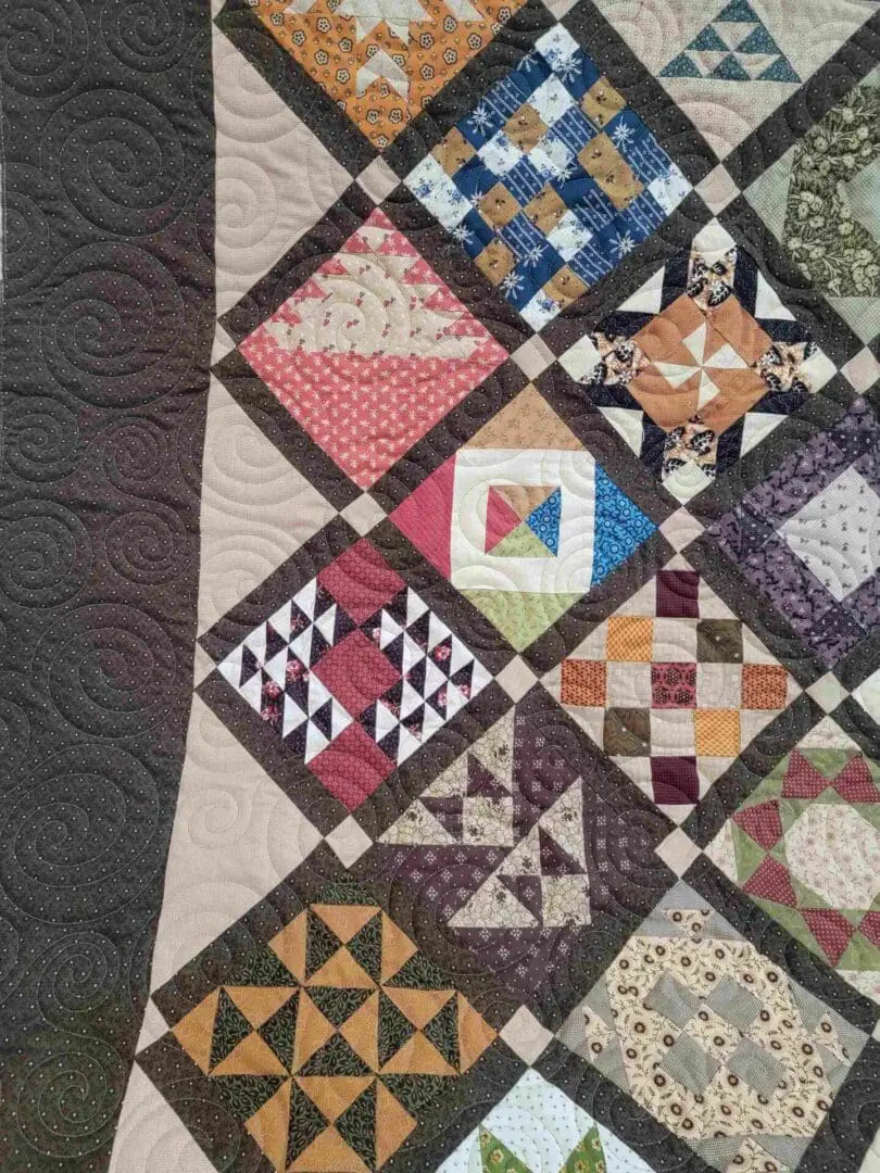 A close up of the quilt with many different colors