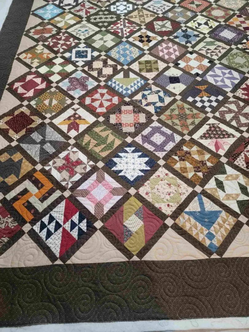 A quilt with many different colors and designs