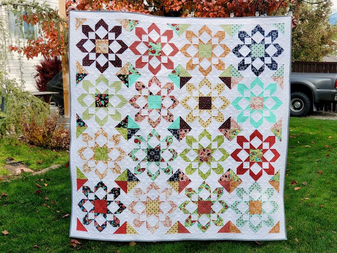 A quilt that is on the ground outside.