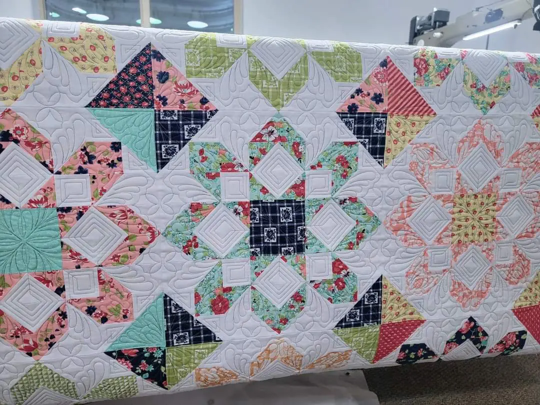 A quilt that is made of different colored fabrics.