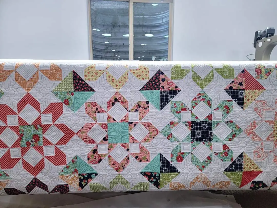 A quilt that is made of different colored fabrics.