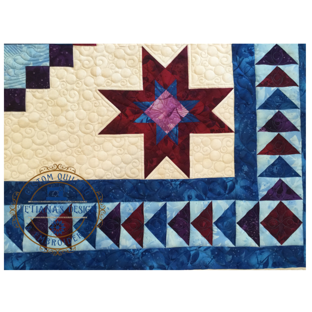 A quilt with a star and geometric designs.