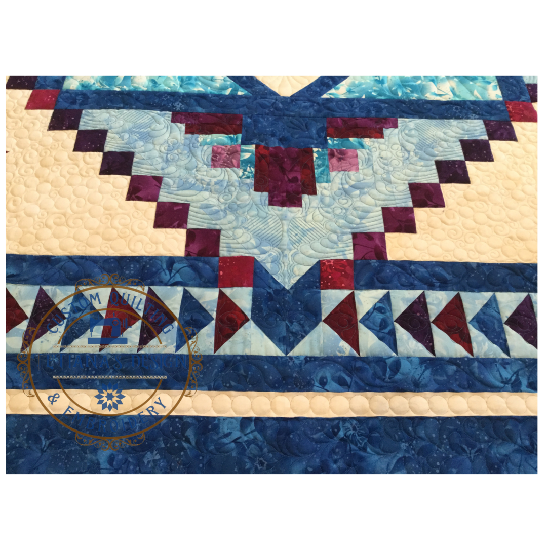 A close up of the blue and red quilt