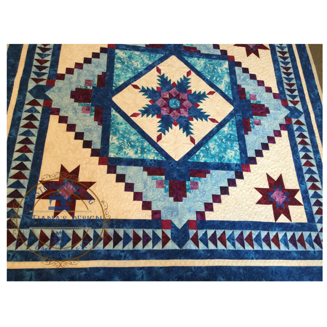 A blue and white quilt with red stars.