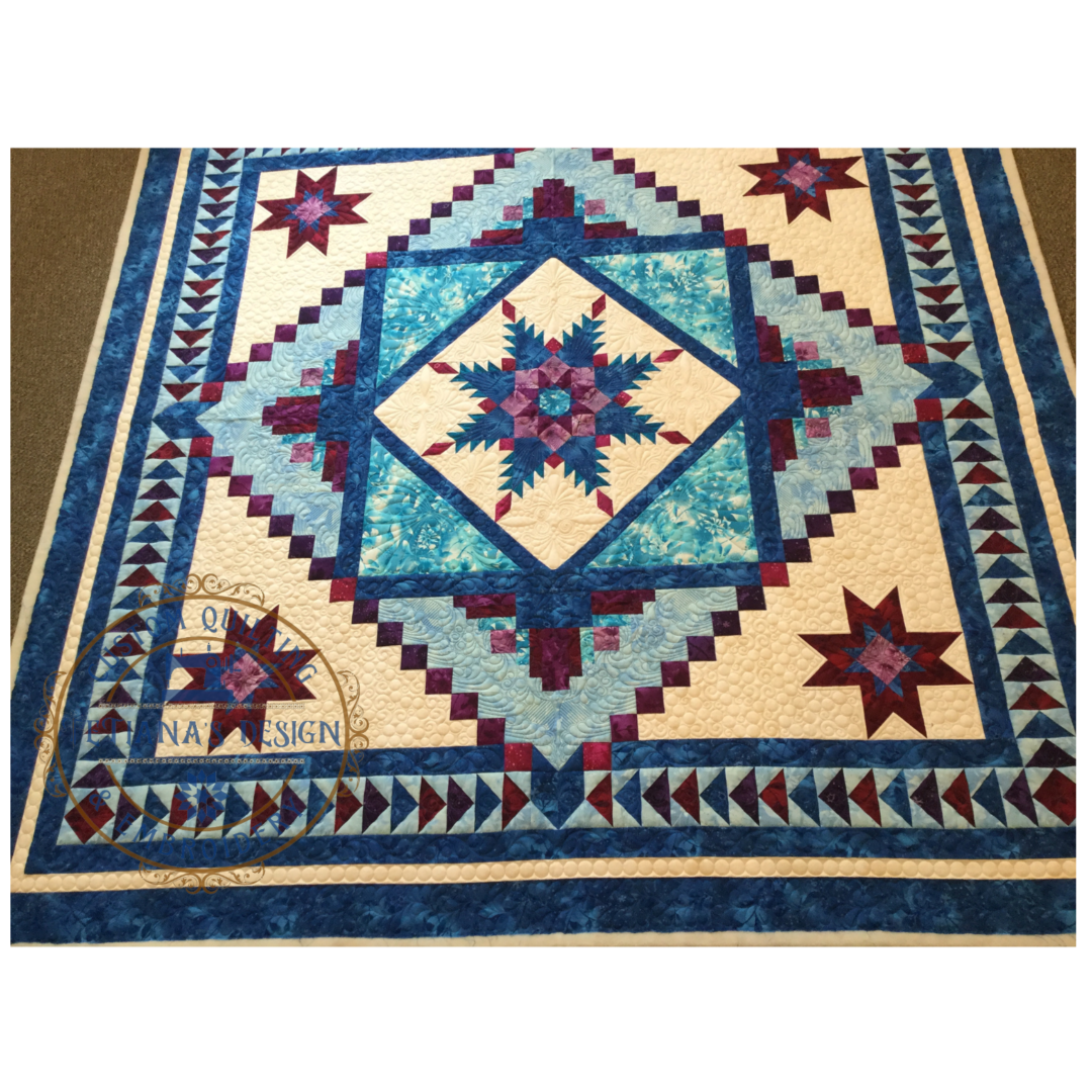 A quilt with blue and red designs on it.