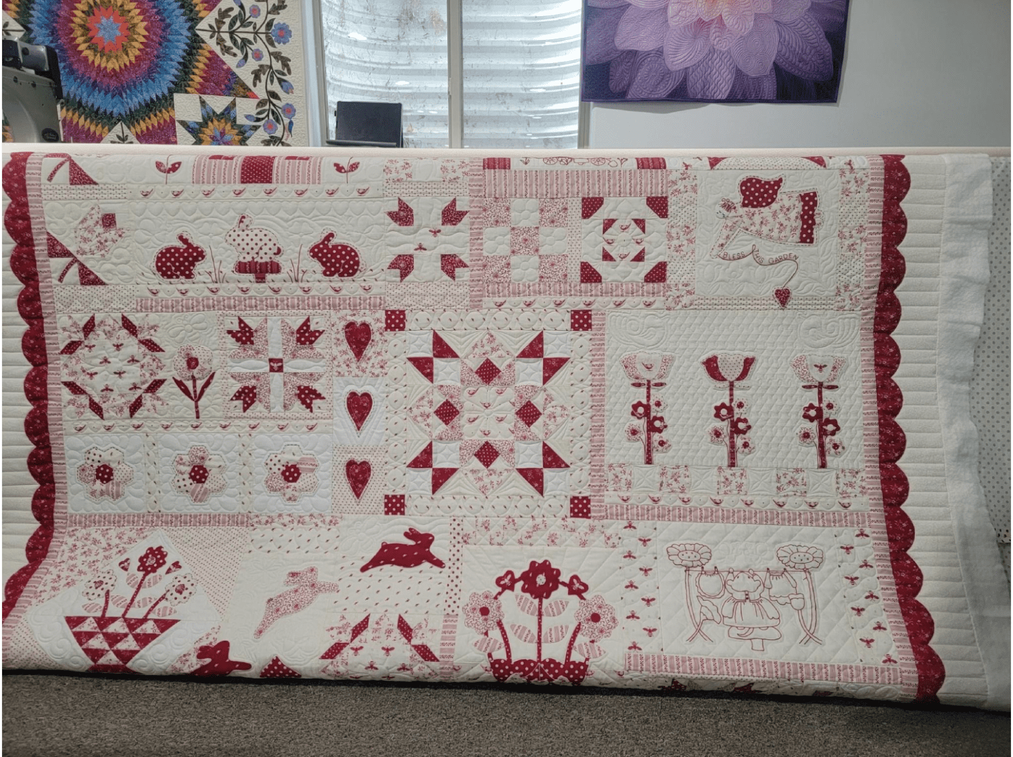 A red and white quilt with some designs on it