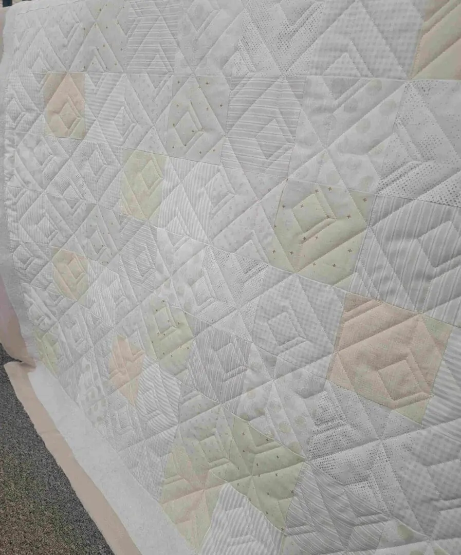 A close up of the quilt on a bed