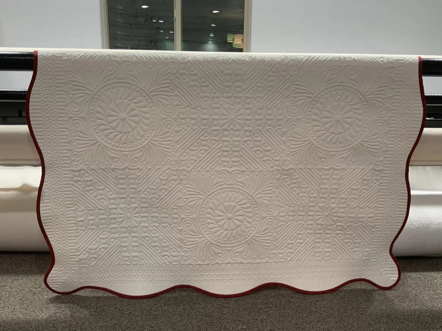 A white table cloth with red trim on it