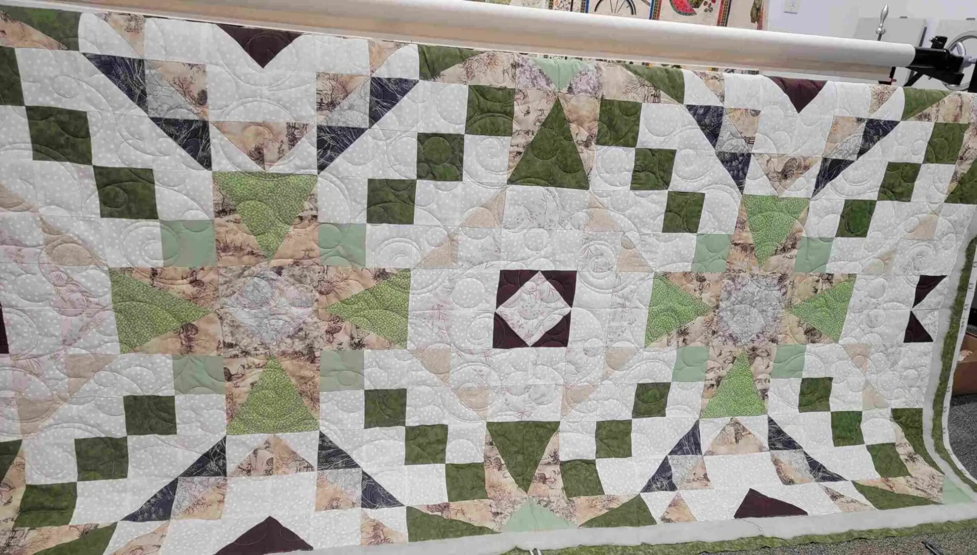 A quilt with green and brown squares on it.