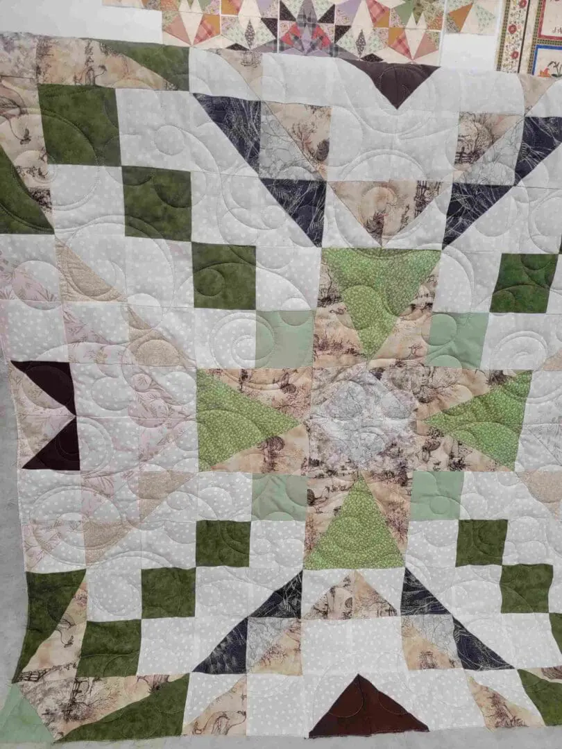 A quilt with green and white squares on it.