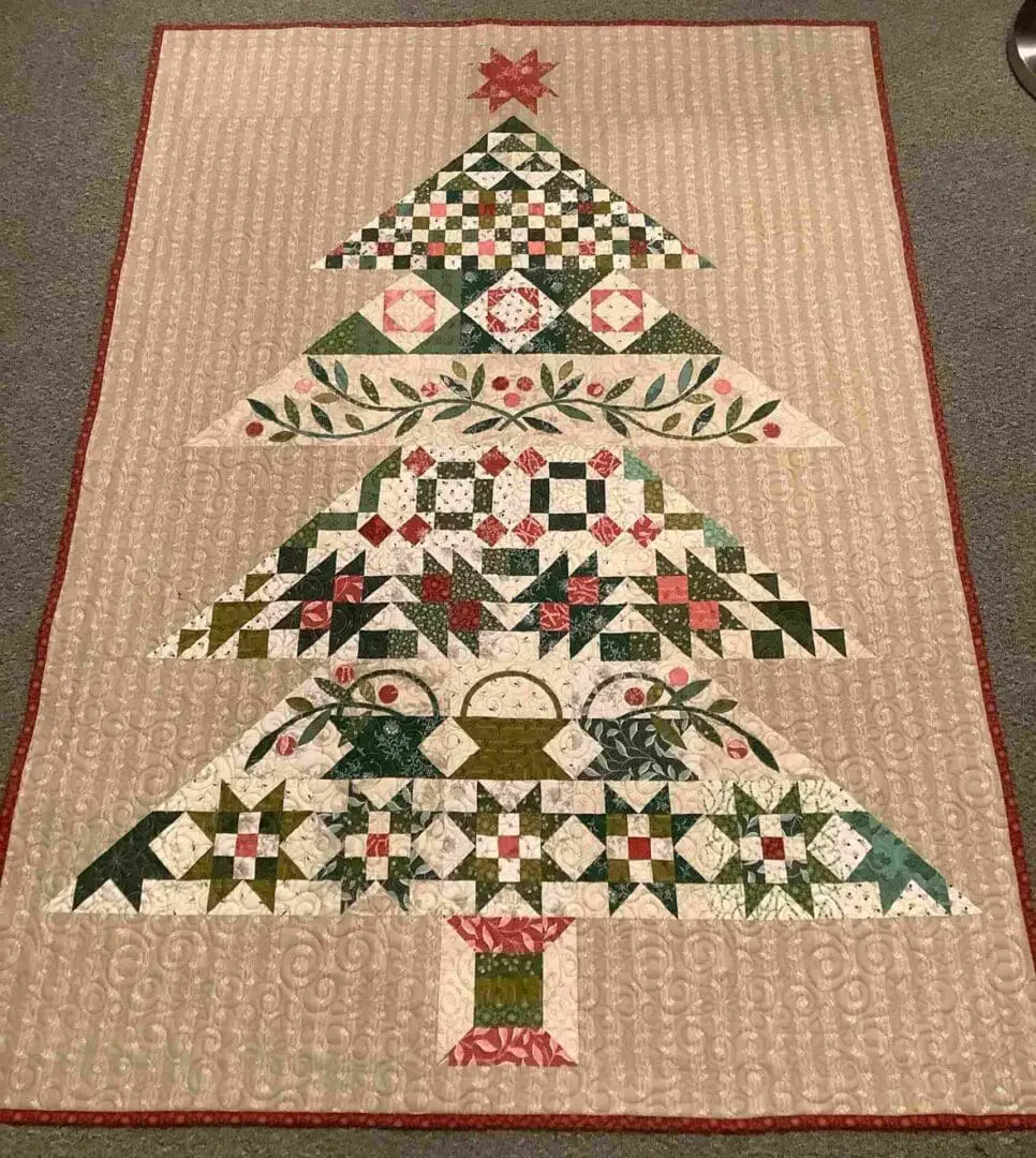 A christmas tree quilt on the floor