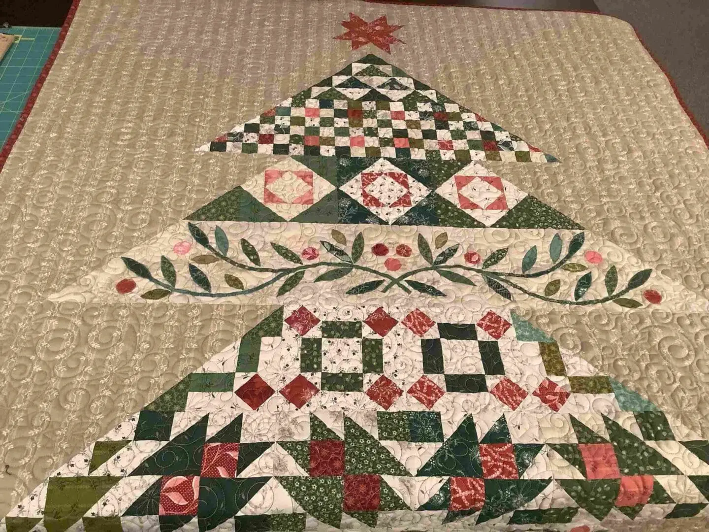 A quilt that is made to look like christmas trees.