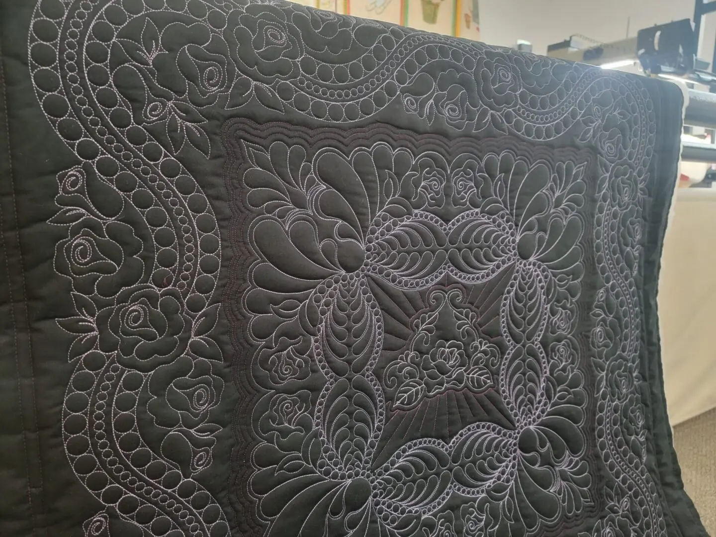 A close up of the lace pattern on a quilt