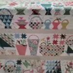 A close up of the quilt with many baskets on it